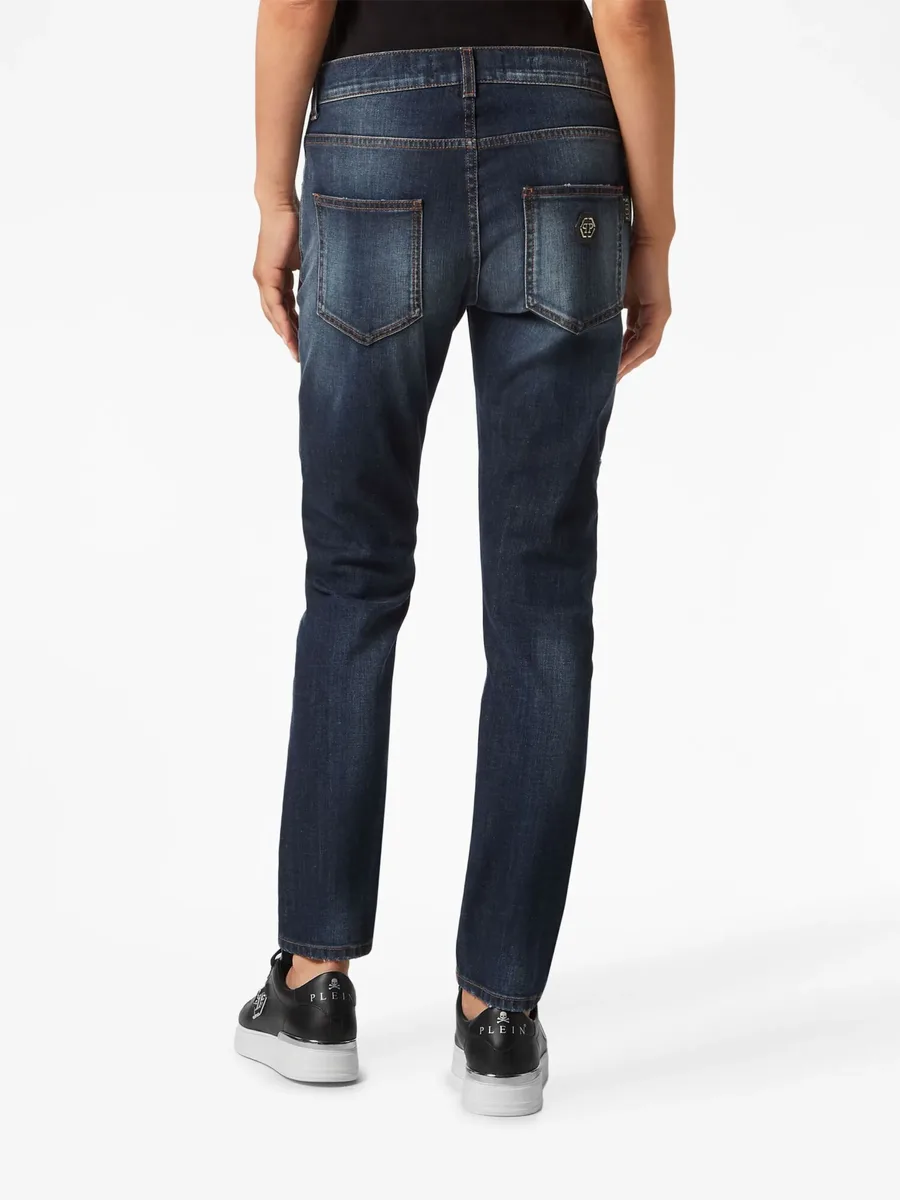 distressed-effect denim trousers 8